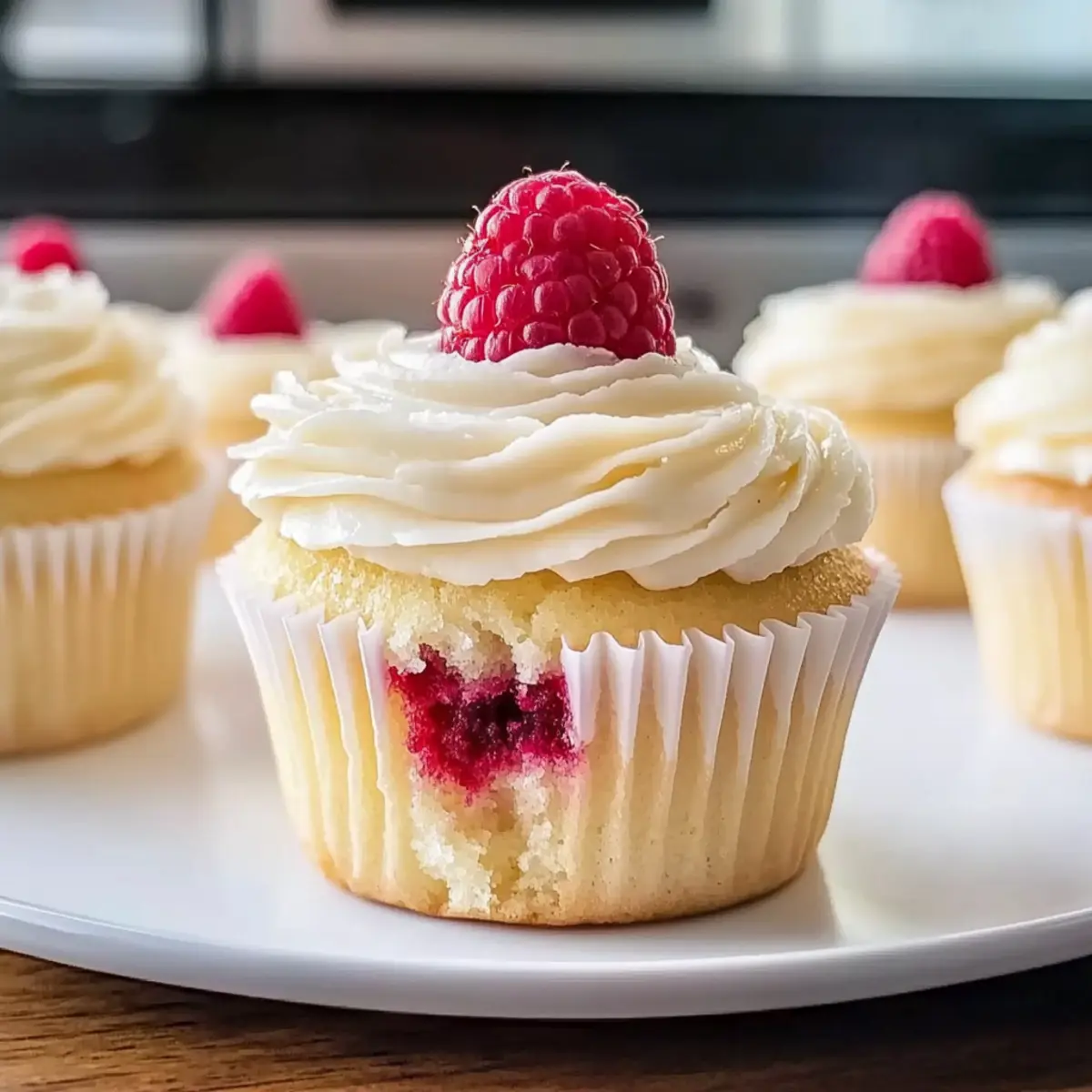 Almond Wedding Cake Cupcakes with Raspberry Filling Bliss